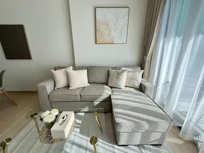 a living room with a couch and a table at Comfortable 1br In Jvc Balcony Free Parking in Dubai