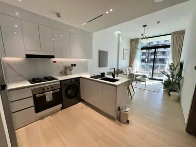 a kitchen with a sink and a stove top oven at Comfortable 1br In Jvc Balcony Free Parking in Dubai