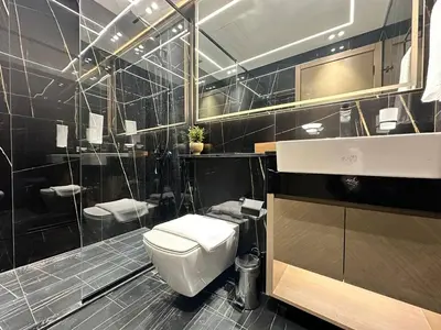 a bathroom with a toilet and a sink at Modern 1br In Jvc Balcony, Pool & Parking in Dubai
