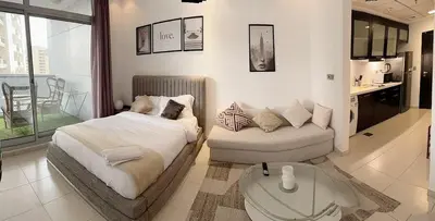 a bedroom with a bed and a couch and a table at Chic Studio in Dubai Marina in Dubai