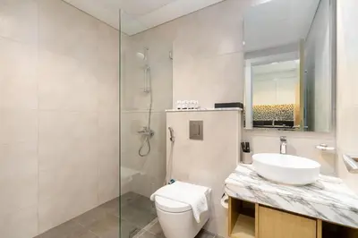 a bathroom with a toilet and a sink and a shower at Aykon City Tower I Birds Eye View in Dubai