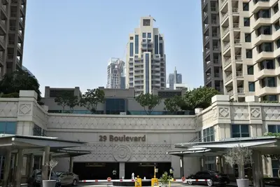 a building in a city with tall buildings at La Vista Holiday Home with burj khalifa & fountain view in Dubai