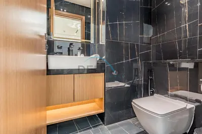 a bathroom with a white toilet and a sink at Cozy 1BR with Balcony in Binghatti House, Jumeirah Village Circle by Deluxe Holiday Homes in Dubai