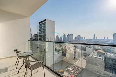 a balcony with a view of a city at Cozy 1BR with Balcony in Binghatti House, Jumeirah Village Circle by Deluxe Holiday Homes in Dubai