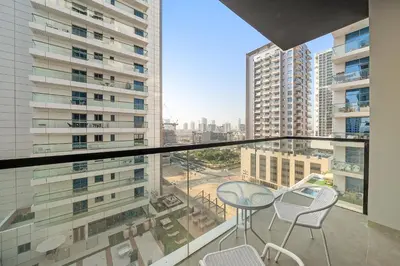 a balcony with a table and chairs in a building at Cozy Studio in Empire Residence in Dubai