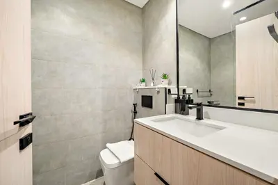 a bathroom with a sink and a toilet at Cozy Studio in Empire Residence in Dubai