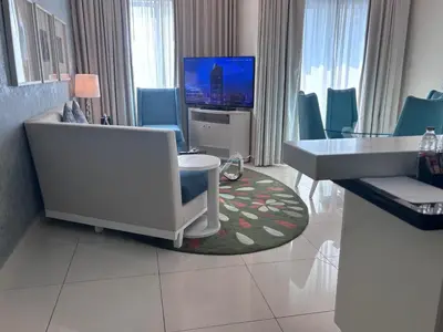 a hotel room with a sink and a living room at Dubai mall area in Dubai
