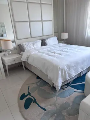 a bedroom with a large bed and a rug at Dubai mall area in Dubai