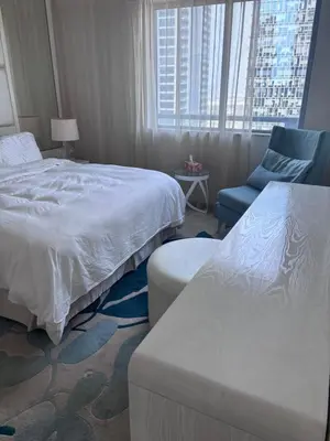 a hotel room with two beds and a chair at Dubai mall area in Dubai