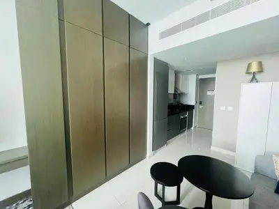 a living room with a black table and chairs at Luxury Studio Near Burj Khalifa in Dubai