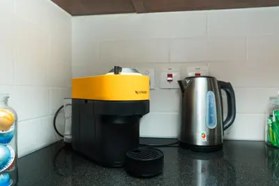 a coffeemaker and a coffee maker on a counter at King 1BR Apartment With Burj Khalifa & Fountain View in Dubai