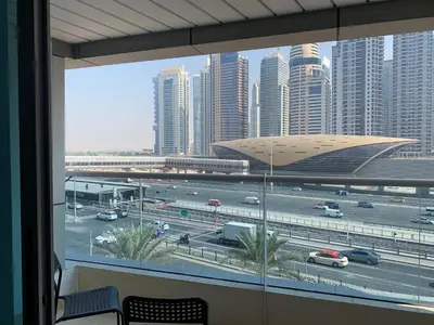 a view of a city from a window with cars at Cozy home marina in Dubai