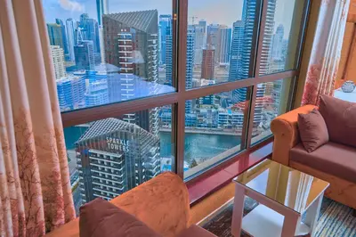 a room with a large window with a view of a city at ROYAL BEACH RESiDENCES 1 in Dubai