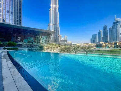 a large swimming pool in a city with tall buildings at The Smart Concierge - Signature Grande in Dubai