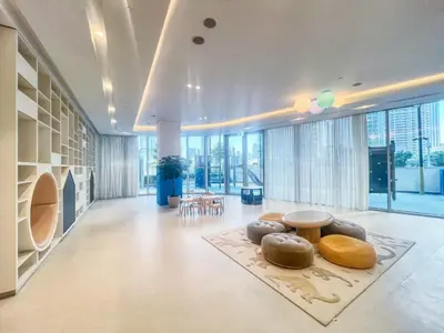 a living room with a table and some chairs at The Smart Concierge - Signature Grande in Dubai