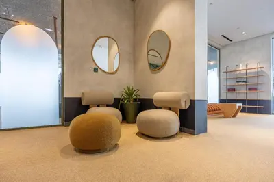 a waiting room with two chairs and two mirrors at Mood Living 22 in Dubai