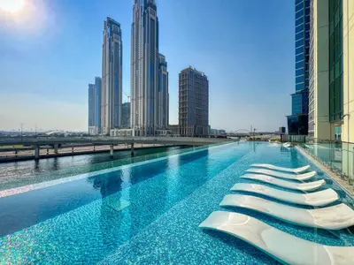 a swimming pool in a city with tall buildings at The Smart Concierge - Urban Oasis by Missoni in Dubai