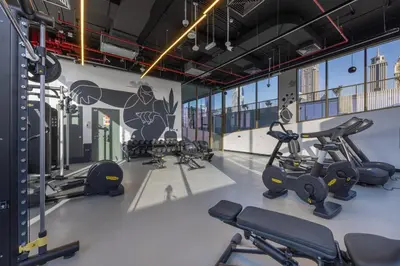 a gym with treadmills and cardio equipment in a building at Mood Living 45 in Dubai
