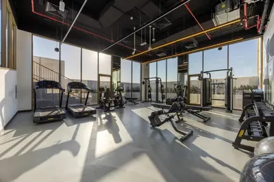 a gym with treadmills and machines in a building at Mood Living 45 in Dubai