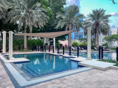 a swimming pool with a canopy and palm trees at The Smart Concierge - Southridge 1 in Dubai