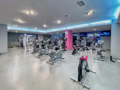 a gym with a bunch of treadmills and machines at The Smart Concierge - Southridge 1 in Dubai