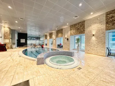 a swimming pool in a large room with a large room at The Smart Concierge - Princess tower in Dubai