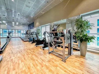 a gym with treadmills and ellipticals in a room at The Smart Concierge - Princess tower in Dubai