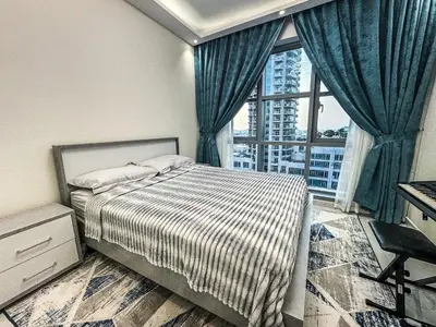 a bedroom with a bed and a large window at DreamShoma -2BR Deluxe Downtown Skyview in Dubai