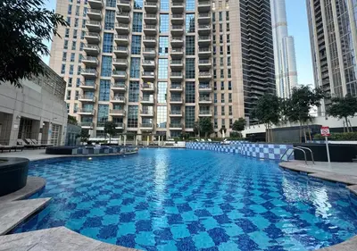 a large swimming pool in front of some tall buildings at DreamShoma -2BR Deluxe Downtown Skyview in Dubai