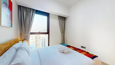 a bedroom with a white bed with a large window at Vacationer l Marvel Super Hero Themed 3 Bedroom l Dubai Fountain Views in Downtown in Dubai
