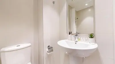 a white bathroom with a toilet and a sink at Vacationer l Marvel Super Hero Themed 3 Bedroom l Dubai Fountain Views in Downtown in Dubai