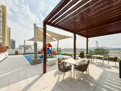 a pavilion with a table and chairs on a patio at Serene 1-Bedroom Retreat in Azizi Riviera with Calming Tones in Dubai