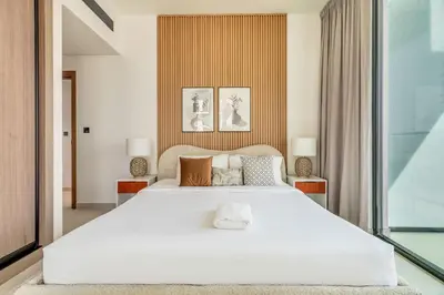 a bedroom with a large white bed with two lamps at GuestReady - Prestigious haven in JVC in Dubai