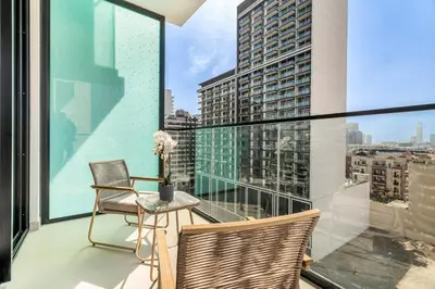 a balcony with two chairs and a table on a building at GuestReady - Prestigious haven in JVC in Dubai