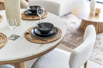 a table with plates and wine glasses on it at GuestReady - Prestigious haven in JVC in Dubai