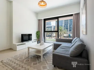 a living room with a couch and a table at Stylish 1BR in Act One, Downtown Near Burj Khalifa in Dubai
