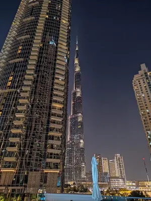 two tall skyscrapers in a city at night at Stylish 1BR in Act One, Downtown Near Burj Khalifa in Dubai