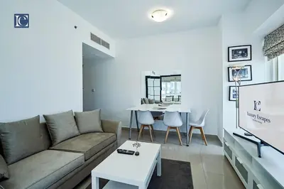 a living room with a couch and a table at Cozy 1-Bedroom Apartment in N2 Lakepoint Tower JLT in Dubai