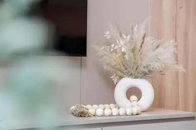 a white vase sitting on a counter with a bunch of eggs at Amazing 2BR Home Burj Khalifa View Steps Walk to DubaiMall in Dubai
