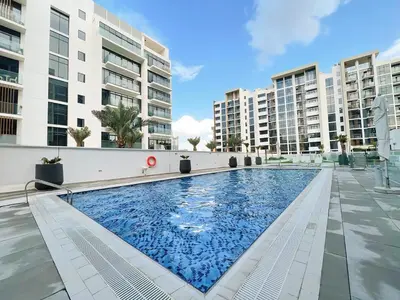 a swimming pool in the middle of a building at Brand New Spacious 3-BedroomIAzizi Riviera 16 in Dubai