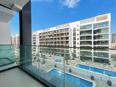 a view from the balcony of a building with a swimming pool at Brand New Spacious 3-BedroomIAzizi Riviera 16 in Dubai
