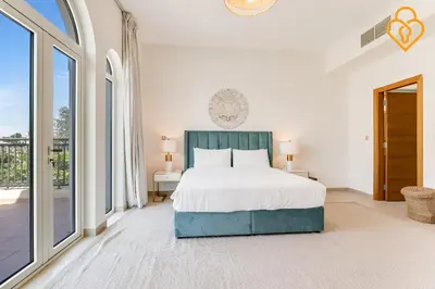 a bedroom with a bed and large windows at keysplease 4 BR Villa private pool, Jumeirah Park in Dubai