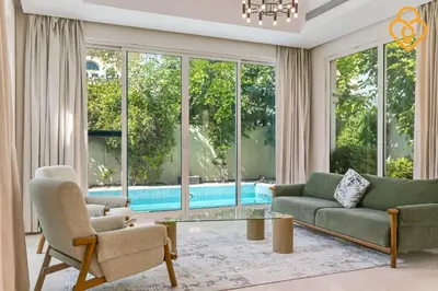 a living room with a couch and chairs and a pool at keysplease 4 BR Villa private pool, Jumeirah Park in Dubai
