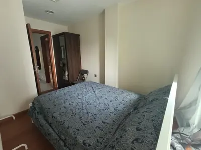 a bedroom with a bed with a blue comforter at In the heart of Dubai in Dubai