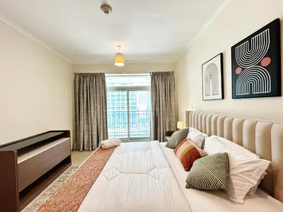 a bedroom with a large bed and a window at Step into Sophistication - Stylish 1-BR Apartment in Downtown Dubai by petals Holiday Homes in Dubai