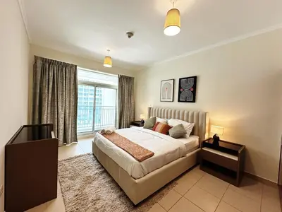 a bedroom with a large bed and a window at Step into Sophistication - Stylish 1-BR Apartment in Downtown Dubai by petals Holiday Homes in Dubai