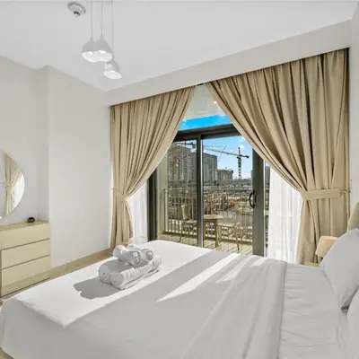a bedroom with a white bed and a large window at Park Point C-1 bedroom for monthly stay-1005 in Dubai