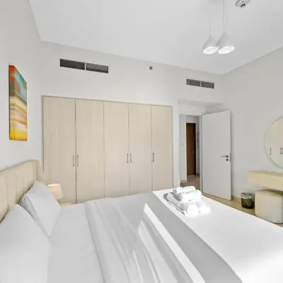 a bedroom with a large white bed with towels on it at Park Point C-1 bedroom for monthly stay-1005 in Dubai