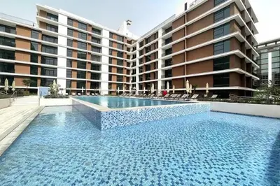 a large swimming pool in front of a building at Park Point C-1 bedroom for monthly stay-1005 in Dubai