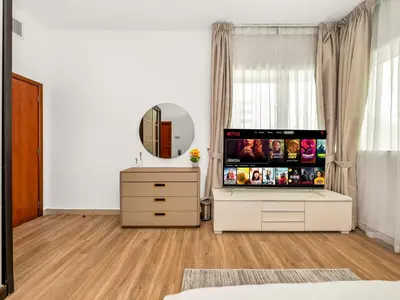 a white room with a mirror and a dresser at Spacious 3BR High Floor Palm View in Dubai Marina in Dubai